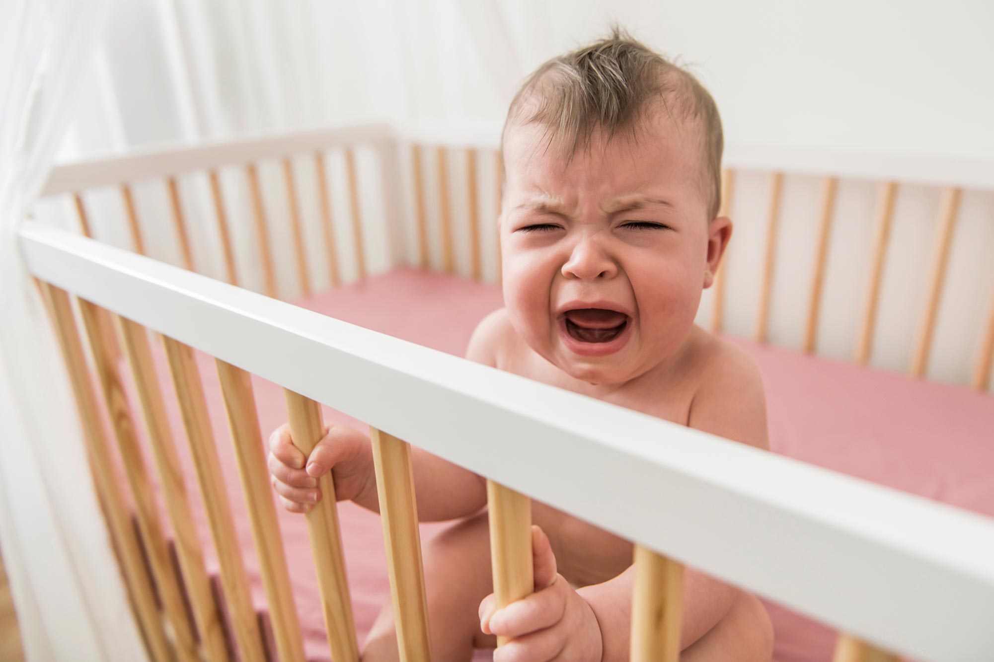 infant in crib, crying